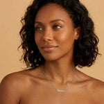 Signature Name Necklace worn by a woman, featuring the name 'Amelia' in elegant script.