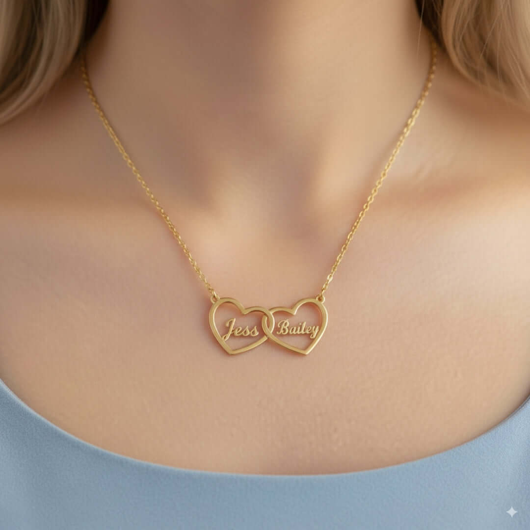 Two Hearts Necklace in gold featuring personalized engraving of names Tess and Bailey, symbolizing love and bond.