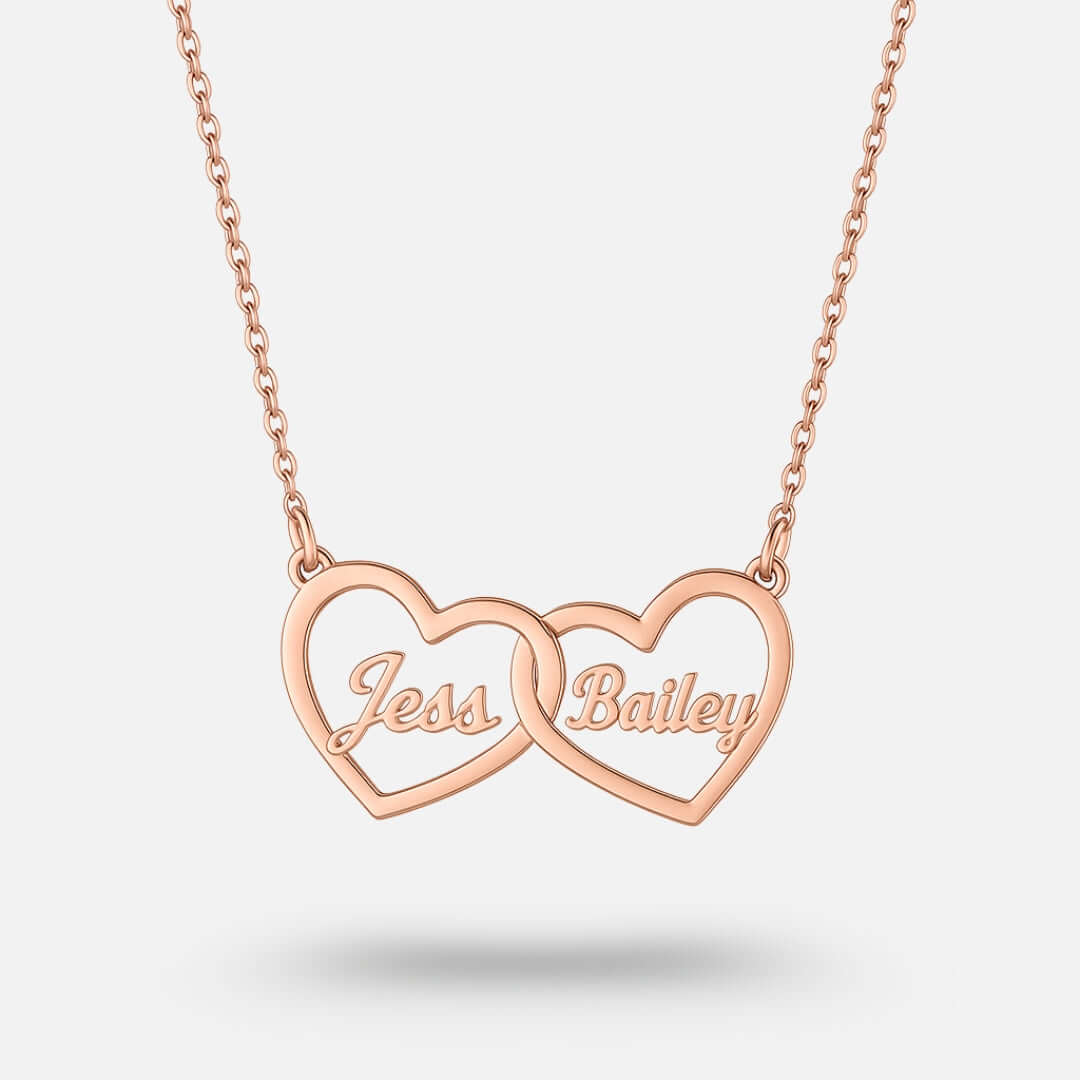Two Hearts Necklace in rose gold with personalized engraving of names Jess and Bailey, symbolizing love and bond.