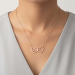 Two Hearts Necklace in rose gold with engraving, personalized with names Jess and Bailey, symbolizing love and bond.