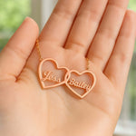 Two Hearts Necklace in rose gold featuring personalized engravings of names Jess and Bailey, symbolizing love and bond.