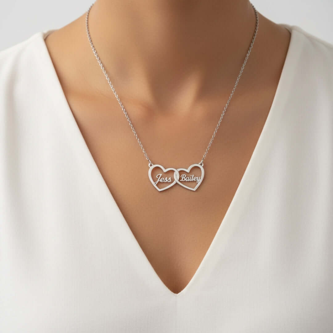 Two Hearts Necklace in silver with personalized engraving of names Jess and Bailey, symbolizing love and bond.